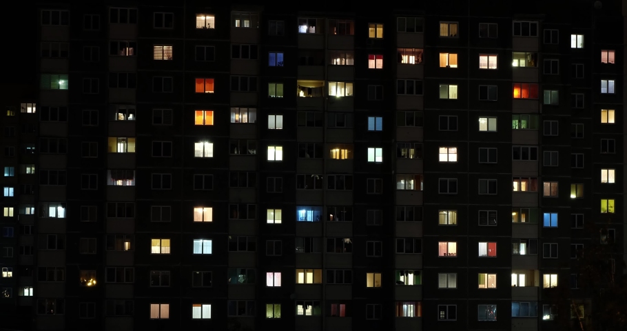 Night panorama time lapse of light in windows of multistory buildings with zoom. life in big city. Serenade of light Royalty-Free Stock Footage #1038385361