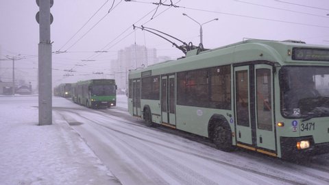 Heavy snowfall in the city, traffic of buses and trolleybuses, winter MINSK, BELARUS - 03.02.19