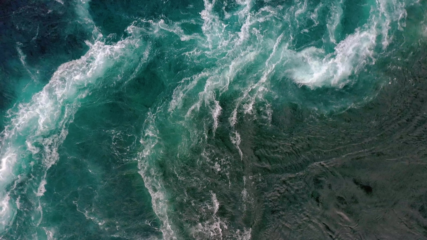 Waves of water of the river and the sea meet each other during high tide and low tide. Whirlpools of the maelstrom of Saltstraumen, Nordland, Norway Royalty-Free Stock Footage #1038388949