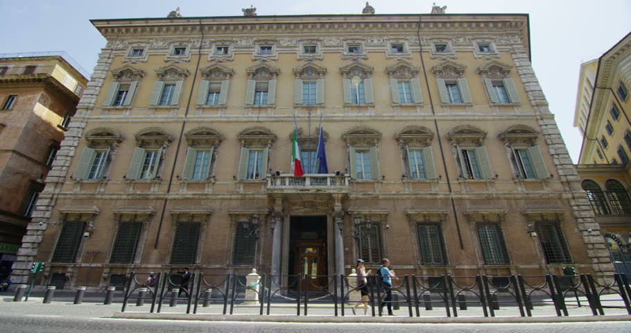 Slow motion of Madama Palace, house of the Senate of the Italian Republic in Rome, Italy (with moving flags)