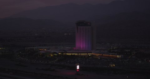 Helicopter aerial, slow zoom out of Morongo Casino sign brightly lit, night