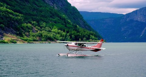 EIDFJORD, NORWAY - JUNE 08, 2019: The Floatplane on the water landed in the fjord Eidfjord, Norway