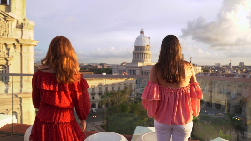 A tracking shot of two American women gazing out from the famous Kempinski hotel