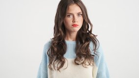 Attractive serious brown haired girl in sweater angrily showing no gesture with crossed hands on camera isolated