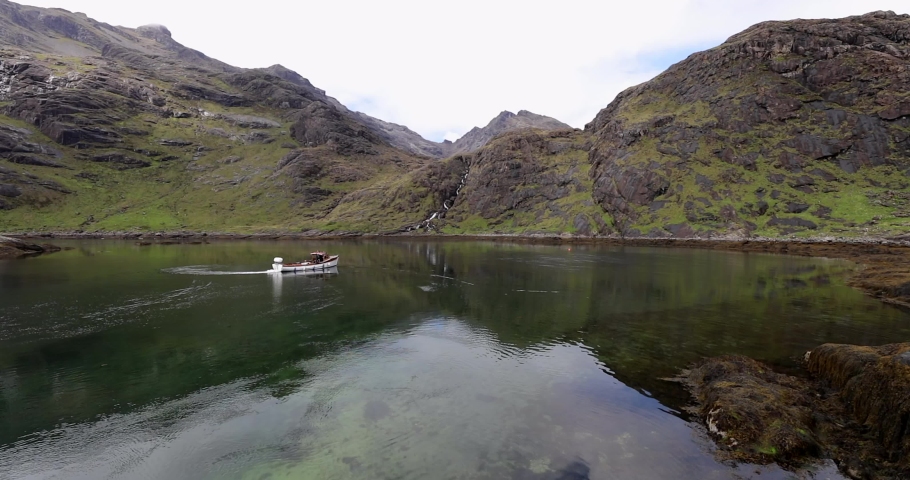 Beautiful scenic landscape of amazing Scotland nature with fishing boat.