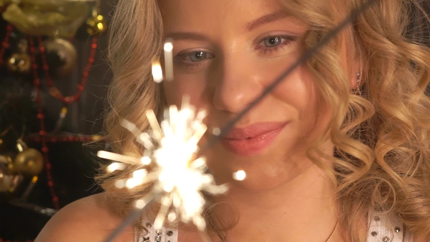 Happy Girl With A Sparkler In Their Hands.