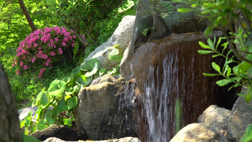 Small source with rocks in Japanese Garden Shukkei-en in Hiroshima in may.