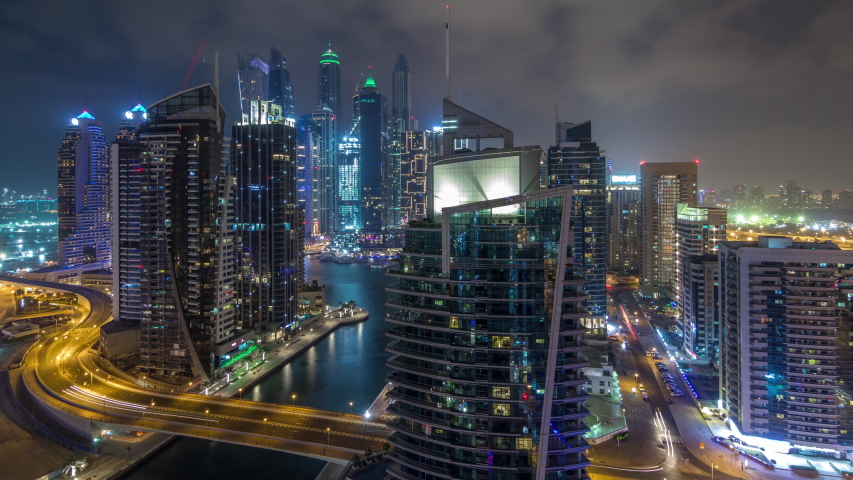 Aerial view of Dubai Marina residential and office skyscrapers with waterfront night timelapse hyperlapse. Floating boats and yachts | Shutterstock HD Video #1038406556
