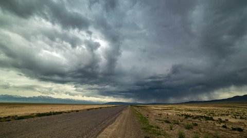 Almaty, Kazakhstan - 15 may 2015: Thunderstorm storm in the desert along the road. 4K TimeLapse.