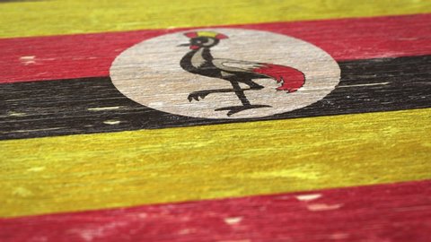 Flag Of Uganda. Detail On Wood, Shallow Depth Of Field, Seamless Loop. High-Quality Animation. Ideal For Your Country / Travel / Political Related Projects. 1080p, 60fps.