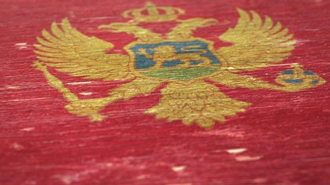 Flag Of Montenegro. Detail On Wood, Shallow Depth Of Field, Seamless Loop. High-Quality Animation. Ideal For Your Country / Travel / Political Related Projects. 1080p, 60fps.