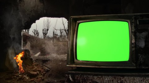 Old TV Green Screen close to a Bonfire on a Demolished Building in a War Zone. You can Replace Green Screen with the Footage or Picture you Want with “Keying” effect in AE (check out tutorials).