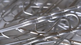 Macro Close-up of Rotating Shiny Metal Paper Clips With Selected Focus