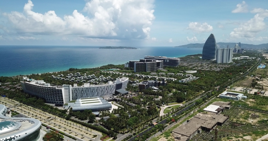 Beautiful Coastal Scenery of Haitang Bay in Sanya, Hainan, with Luxury Hotels and Resorts along the Beach, the Only Tropical Tourism Destination in China. Aerial View. Eyelevel Angle Dolly Out Shot.