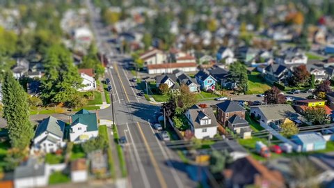 Hyperlapse footage of an aerial view fly-over of an American suburban neighborhood; tilt-shift lens effect