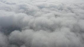 High above clouds by early morning 4K aerial video