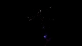 Blowing up of fireworks on black background to create a set salute on video about celebration.