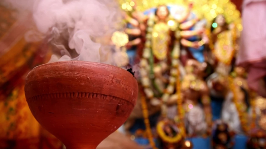 Durga puja or Navratri celebration in Kolkata, West Bengal, India. Dhunachi is a Bengali incense burner used for one of the stages during aarti, or ritualized dance worship. Royalty-Free Stock Footage #1038455966
