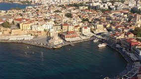 Aerial drone view video of iconic and picturesque Venetian old port of Chania with famous lighthouse and traditional character, Crete island, Greece. Architecture of the Venetian port in Chania.