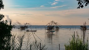 Timelapse 4K of beautiful sunrise with fishing trap in pak pra village, Phatthalung Thailand