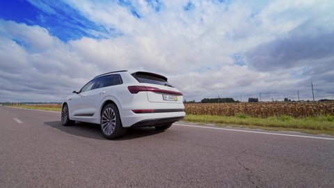 VINNITSA, UKRAINE - September 2019: White luxury car on road on the field background. Very fast driving of audi car on highway under beautiful sky at daylight.
