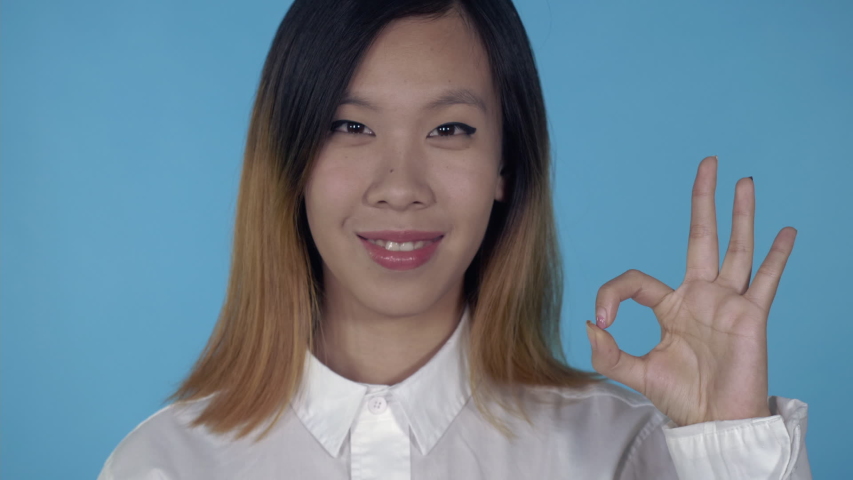 korean happy female showing gesture ok