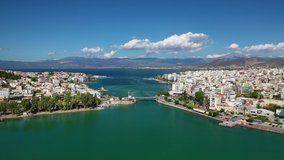 Aerial drone video of iconic town of Halkida or Chalkida with famous old bridge connecting Evoia island with mainland and beautiful clouds, Greece
