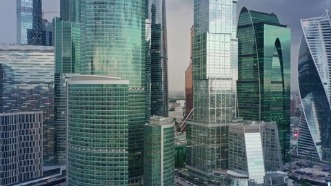 Aerial drone zoom in shot close up of Moscow City glass buildings. Smooth drone shot through Moscow Business Center skyscrapers