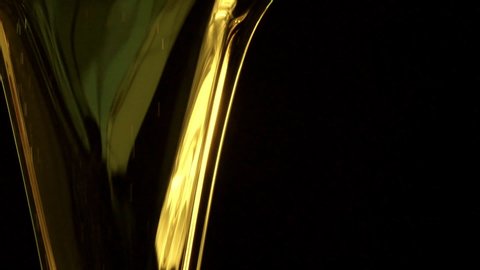 Motor oil pouring on black background. Slow motion
