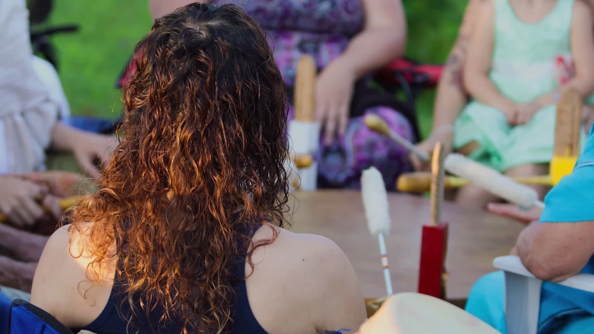 Sacred drums at spiritual singing group. A short clip shot close up on the back of a woman