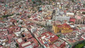 Aerial Drone Shot of a basilica in the colorful downtown of Guanajuato, Mexico