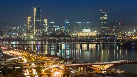 Aerial timelapse of Seoul downtown cityscape with highway roads and Seongsan bridge over Han River in twilight. Seoul, South Korea. Zoom out effect