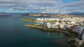 Aerial drone video of famous town of Halkida or Chalkida featuring old bridge connecting Evoia island with mainland Greece with beautiful clouds and deep blue sky