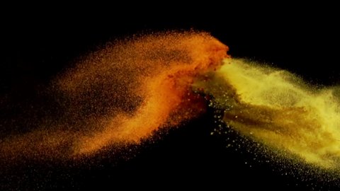 Exotic Spices paprika and curry collide on black background closeup in super slow motion