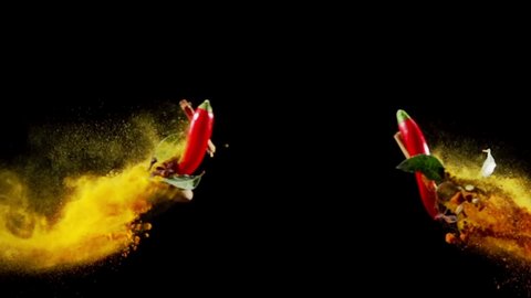 Exotic Spices paprika chili peppercorn bay leaf curry collide on black background super slow motion