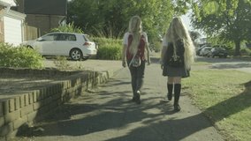 Pre teen twin caucasian girls walking to school - Powered by Shutterstock - Get 15% off with code: PIKWIZARD15