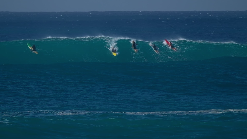 Surfer rides gigantic ocean wave on the North Shore of Oahu, Hawaii