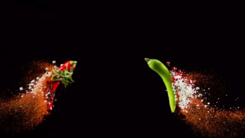 Exotic Spices paprika variation salt and peppercorn collide on black background closeup in super slow motion