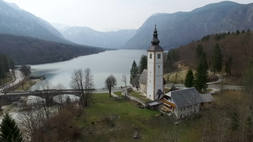 Drone view of bridge and church from the Bohinj lake, Slovenia