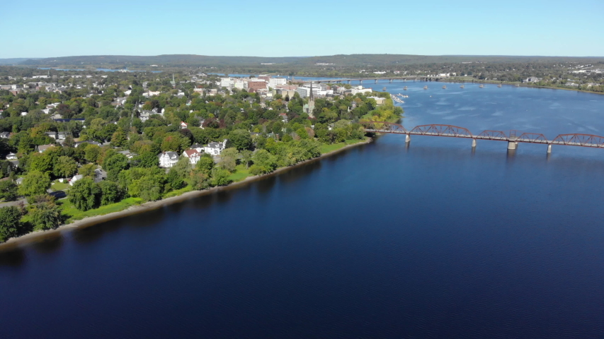 AERIAL: Flying Over The Saint John River Toward Downtown Fredericton. Walking Bridge In The Foreground. Royalty-Free Stock Footage #1038529355