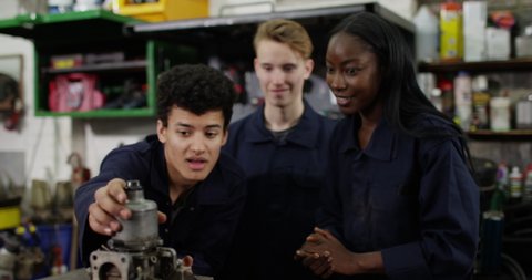 4K Happy & interested trainee mechanics learning from experienced colleague. Slow motion. Stock Video