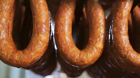 Sausage rings as a finished product, dries in racks. Panorama of the finished sausage products