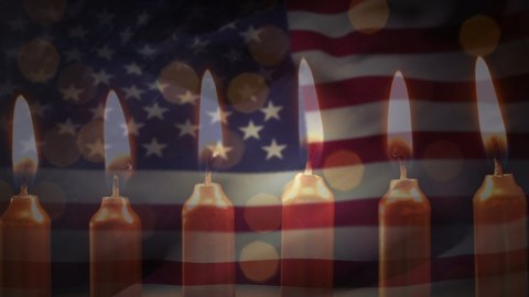 Animation of lit candles burning and flickering lights with a US flag billowing in the background
