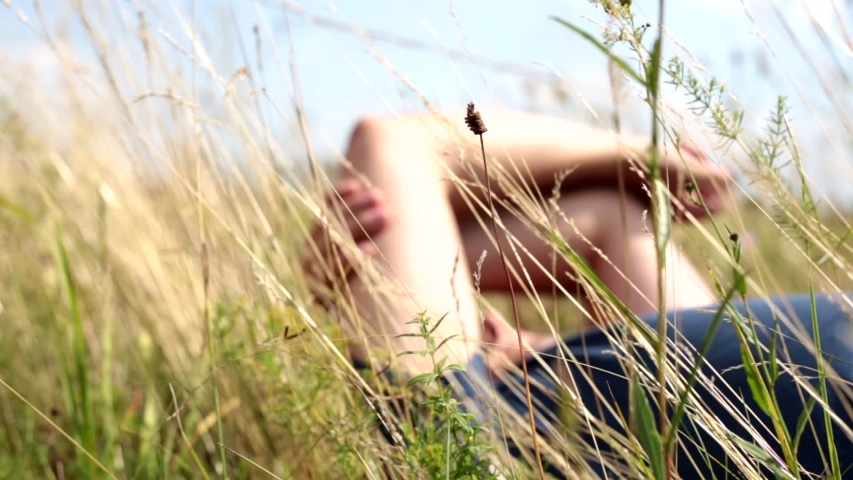 Against the background of grass, a man lies and rests