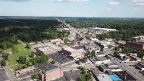 Aerial Drone Footage of Grand River Ave and the Redford Neighborhood. Redford Theater and Detroit Skyline on a beautiful sunny day. Public transportation, and people walking by on the city streets.