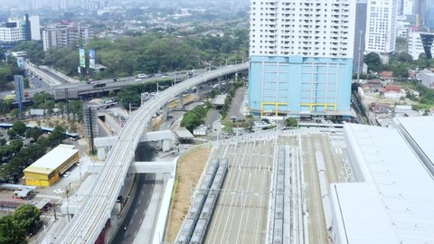 JAKARTA, Indonesia - October 03, 2019: Aerial view of Lebak Bulus MRT Station with MRT depot and elevated track. Shot in 4k resolution from a drone flying from right to left