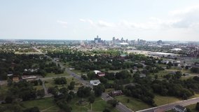 Aerial Drone Footage of Recovery Park and the Chene Ferry Market. Detroit Skyline and abandoned buildings on a sunny day. Public transportation, and people walking by on the city streets.