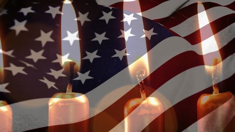 Animation of lit candles burning and flickering lights with a US flag billowing in the background