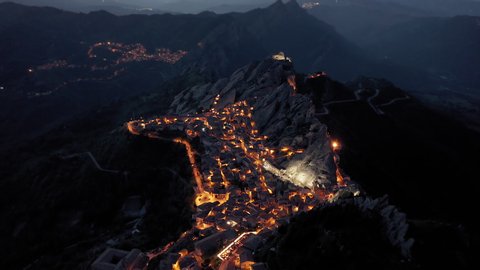 Epic mountain town Pietrapertosa located in Dolomiti lucane mountains in Basilicata region in the southern Italy. Aerial blue hour shot.