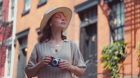 Young tourist with a retro camera in New York City